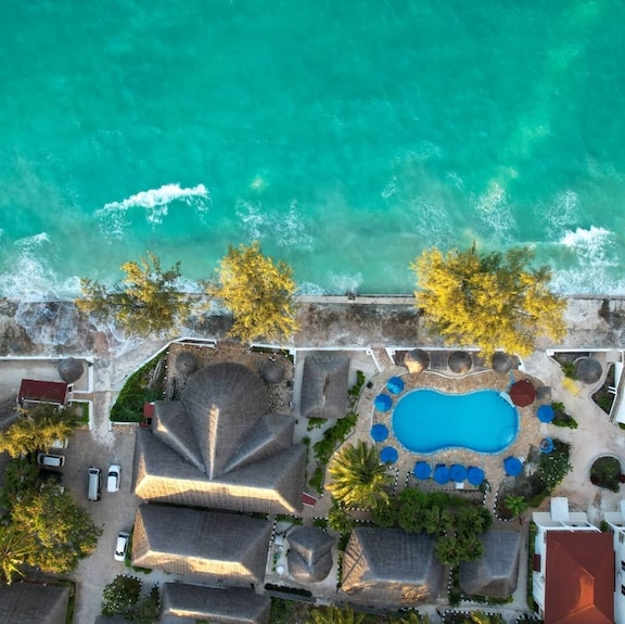 Aerial view of Visitor's Inn property, pool, beach, and Jambiani coastline