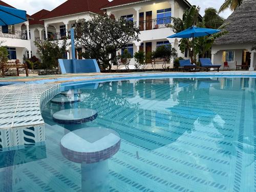 Pool with blue loungers and ocean reflection