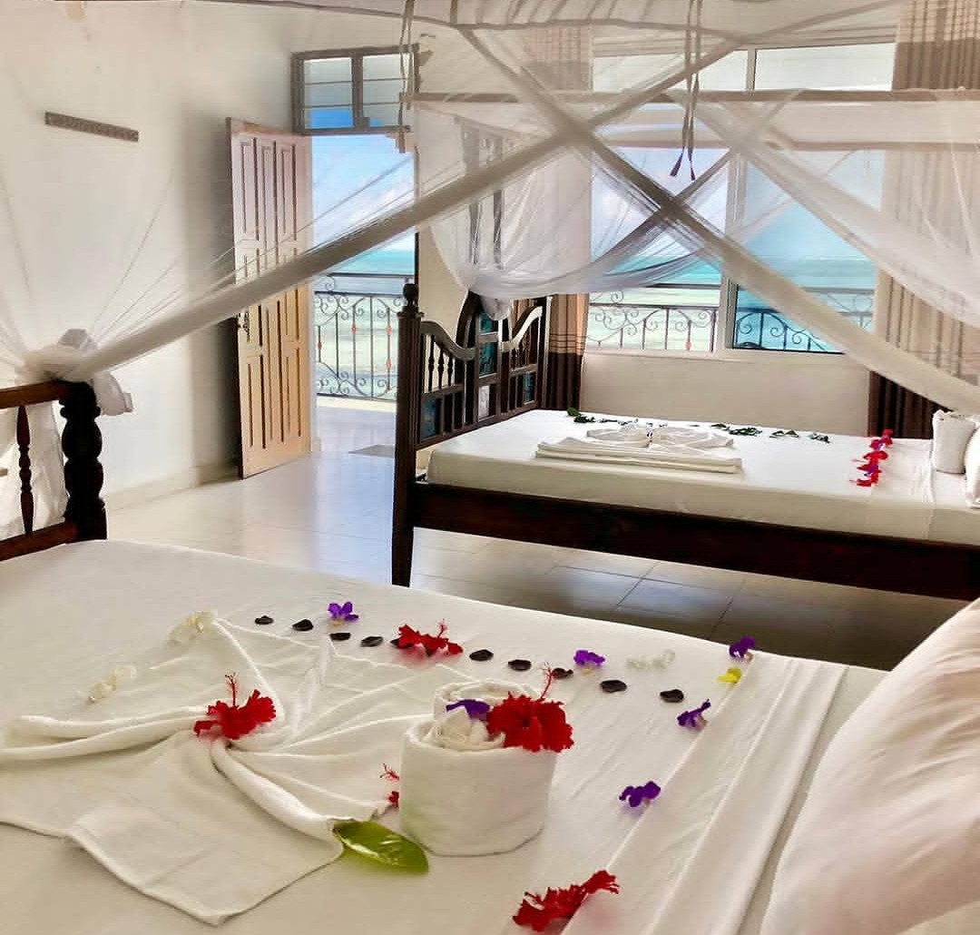 Sea View Double room with king bed and ocean-facing balcony